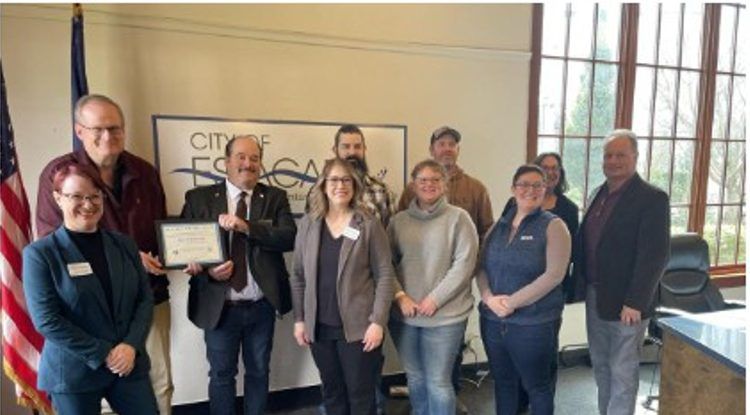 Mayor Drinkwine holds an EPA award certificate with city staff at Estacada City Hall